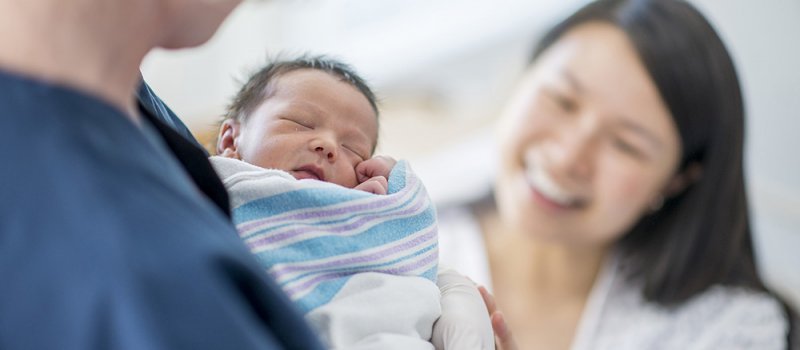 Nurse Holding A Newborn